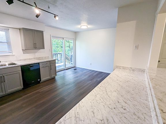 Kitchen looking into the Dining Area and the sliding door leading to the Deck