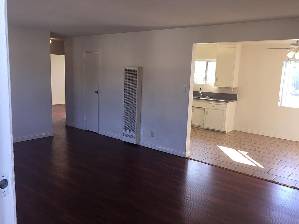 Living Room from Entry Door showing Linen Closet and Entry to Hall to the Left and Dining Area and Kitchen to the Right