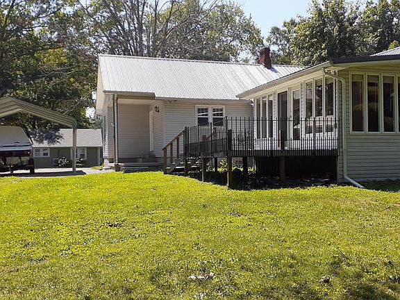 Back of house w/deck and kitchen porch and pet area