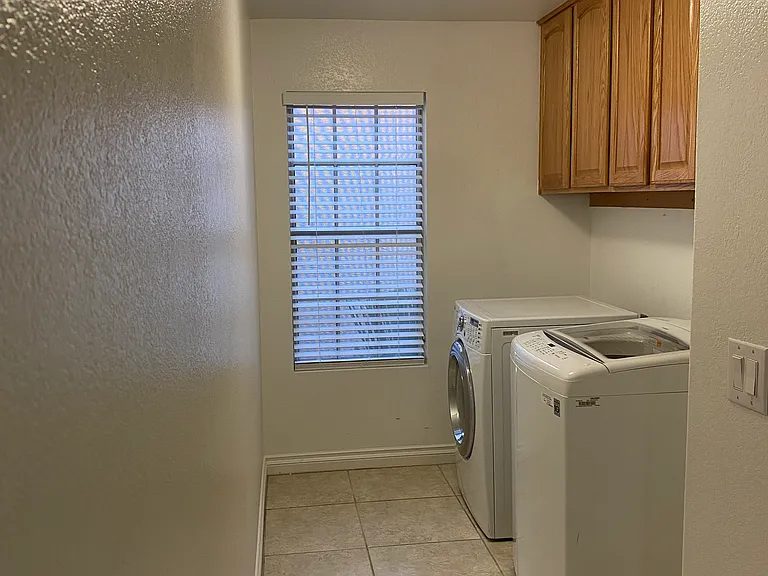 Laundry with custom cabinetry above. Great area tucked away off the kitchen.