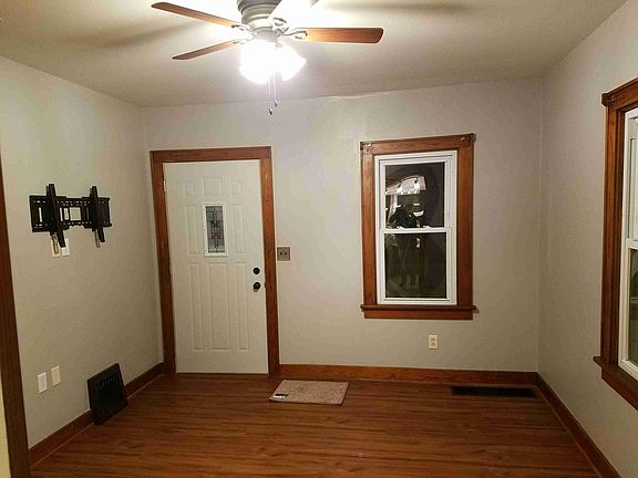 Living room. Newer vinyl wood plank, ceiling fan, paint.