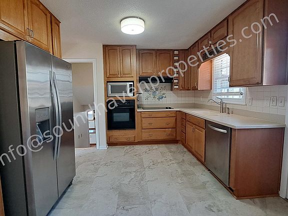 Custom cabinets with soft close, corian countertops, stainless appliances, convection microwave oven, smooth-top range, new LVP