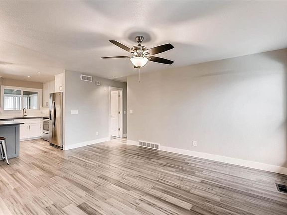 Top of Stairs Looking into Living Room, Kitchen, Bathroom door, and hallway