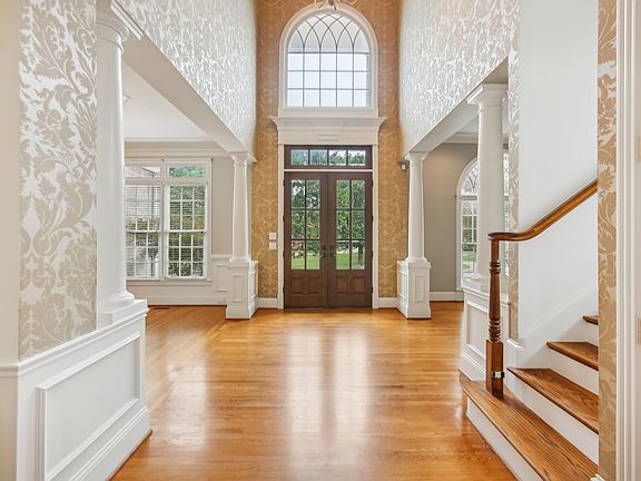 Stunning foyer with high ceilings and abundant natural light! This inviting space sets the tone for luxury and elegance, creating a warm and welcoming atmosphere in this beautiful home. A must-see feature!