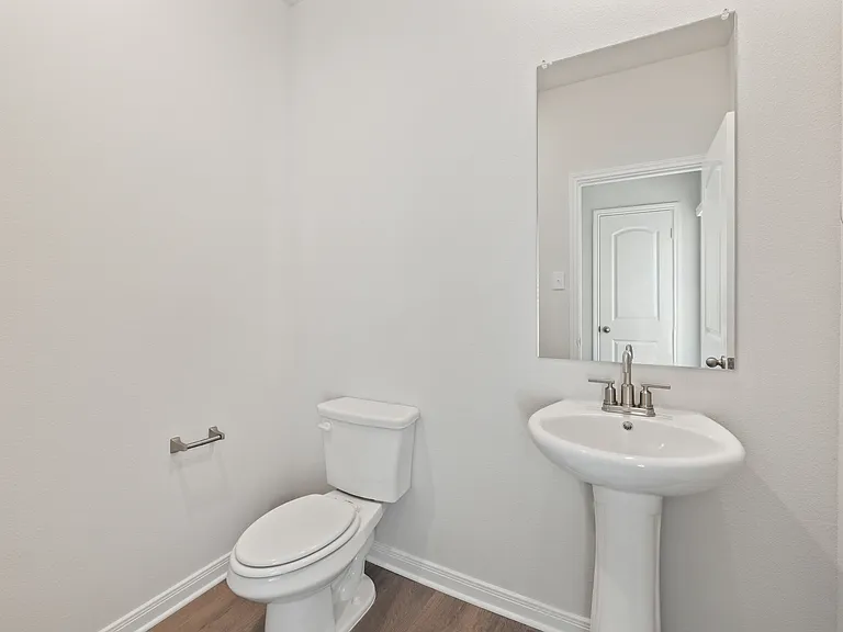 The downstairs powder room sits right off of the family room.