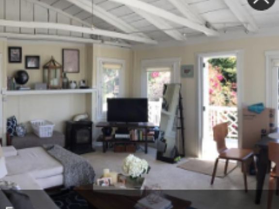 Livingroom with raised ceiling and door to balcony