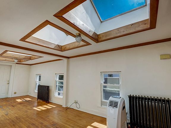 WHAT A COOL SPACE! Look at the skylights. No more radiators because this unit just got central heat and air!!