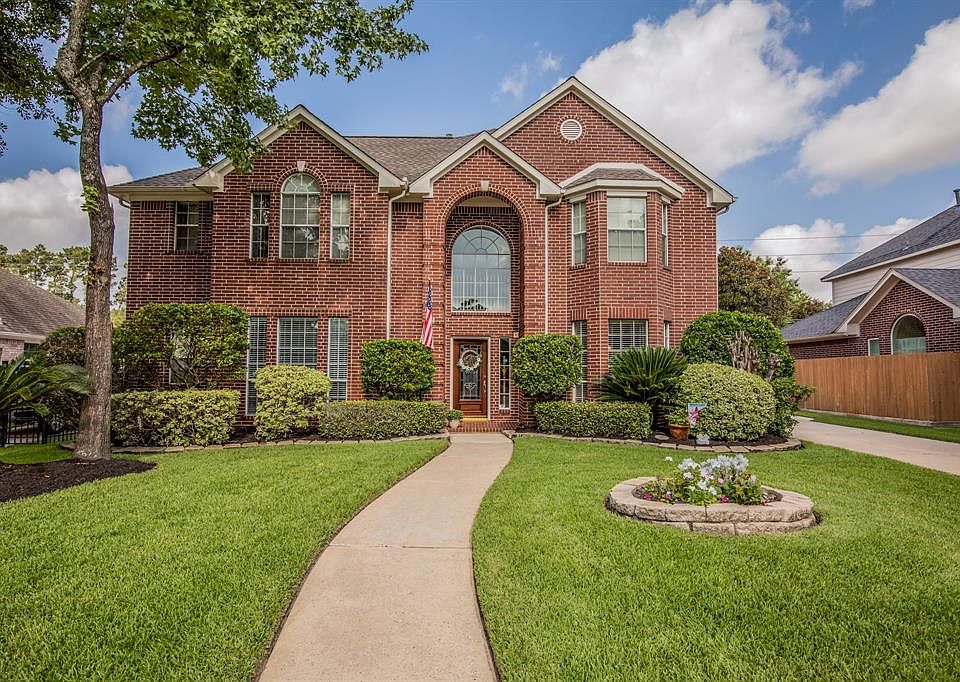 WELCOME to 20211 Forest Drive in the heart of Spring Texas! This stately red brick, lushly landscaped home is waiting for your family.