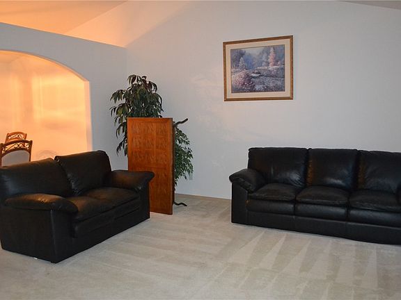 Living room that is spacious and bright with vaulted ceiling.