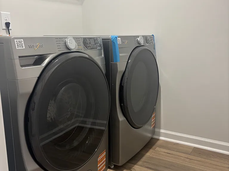 Brand new washer and dryer in hallway next to master bedroom.