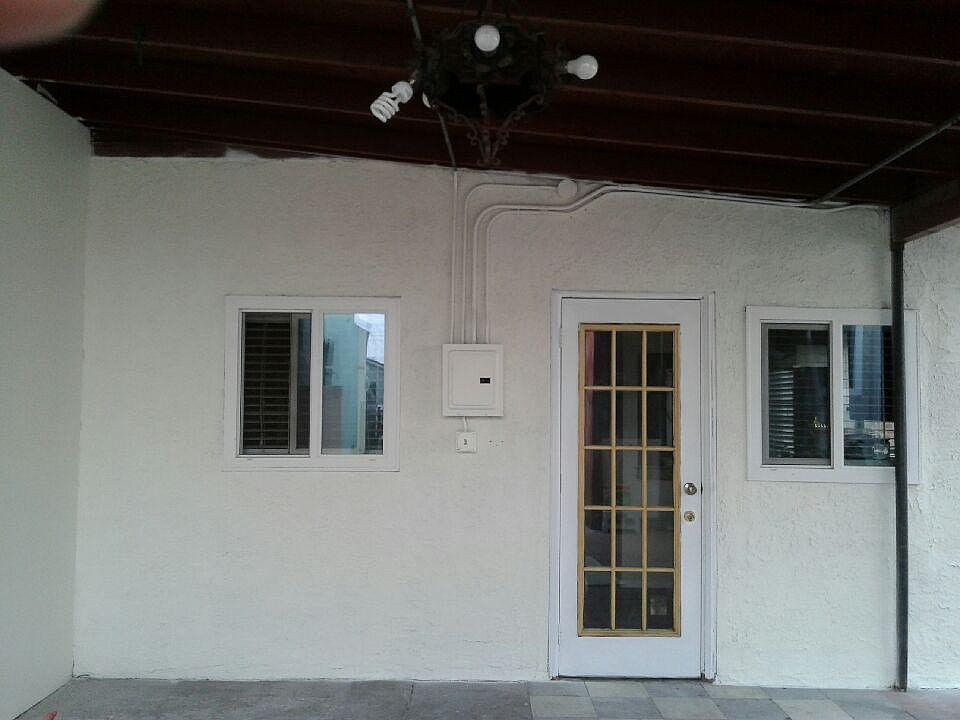 Front View with New Windows and New Stucco.