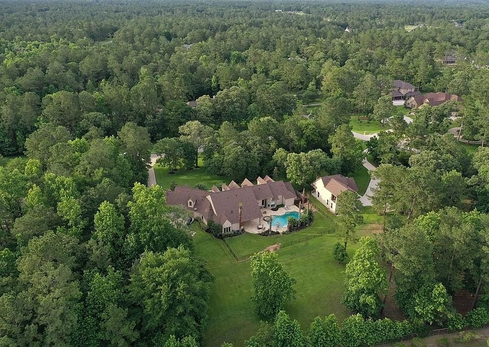 Amazing 1.5 story home with a total of 6 car garages and a golf cart garage! Pool, Guest house, approximately 4 acres with only 1 neighbor that is separated by wooded buffer! GENERATOR! PELLA Windows!