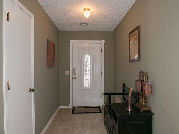 Inviting entryway has coat closet.