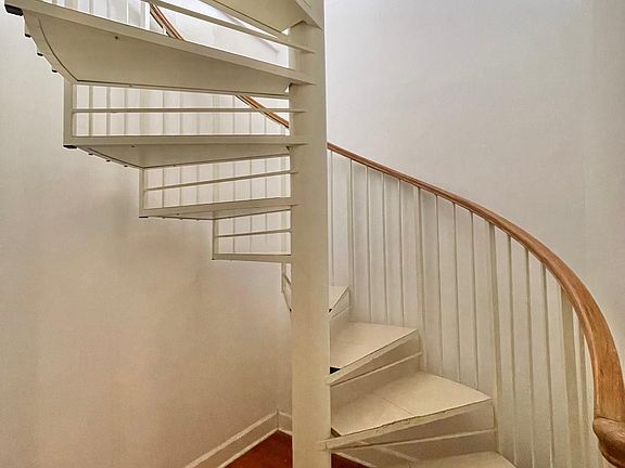 Just inside interior door is a spiral staircase leading to the apartment