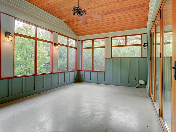 Screened in porch invites you to relax for a while