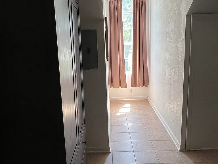 Another view of a dorm window with sun-blocking drapes