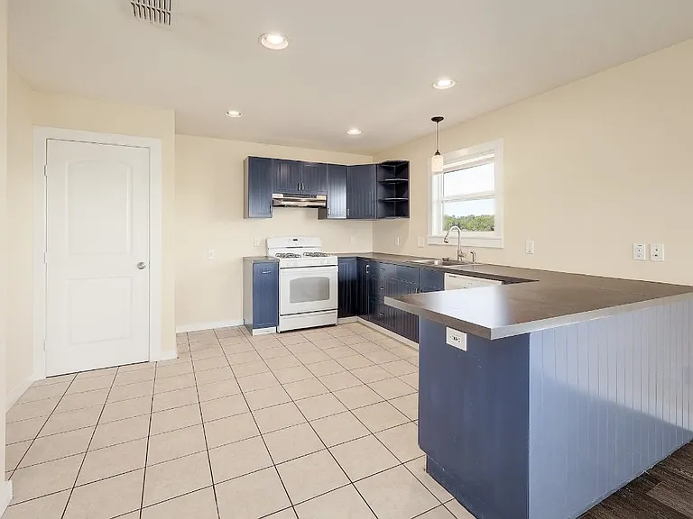 Kitchen has an oven, dishwasher and a refrigerator.
