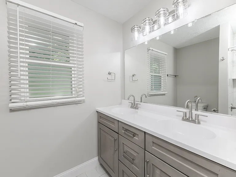 Bathroom 1 - fully remodeled throughout. New tile, shower, vanity, lighting.