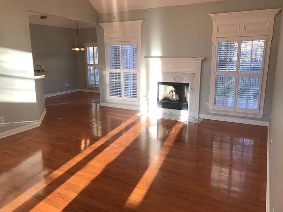 Den with gas logs fireplace and eat in kitchen