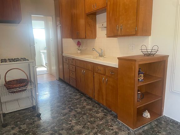Kitchen facing work area and built in bookshelves