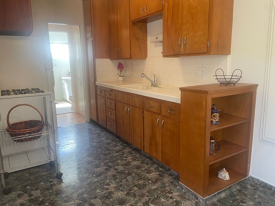 Kitchen facing work area and built in bookshelves