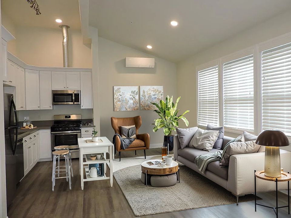 Stunning vaulted ceiling open floor plan. Furnishings are for staging only. This is an unfurnished apartment.