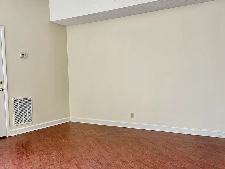 main room. door to half-bath and laundry room left. great natural light and high ceilings!
