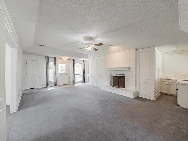 LIVING ROOM WITH FIREPLACE AND WET BAR AREA