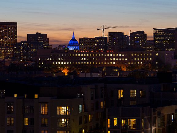 evening view from private rooftop deck with City Hall lit up
