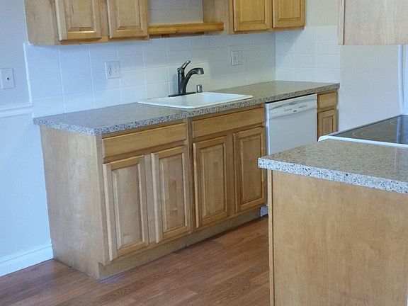 Kitchen has new quartz countertops and tile backsplash