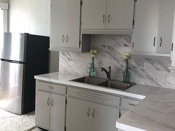 Freshly painted updated counters, backsplash, new stove now installed new refrigerator ,