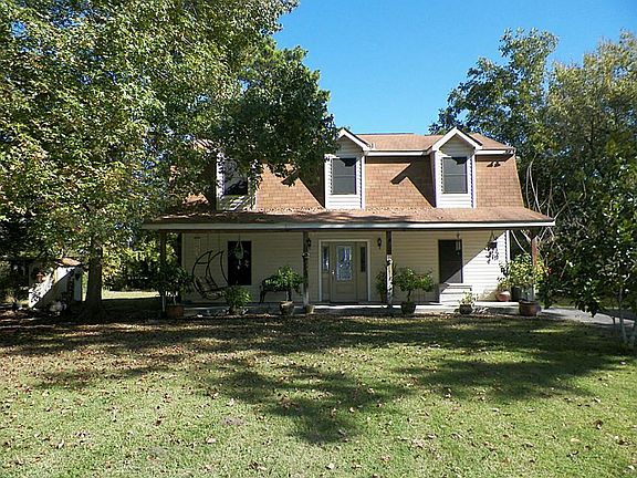 Mature trees provide a cool place on the front porch - perfect for morning coffee.
