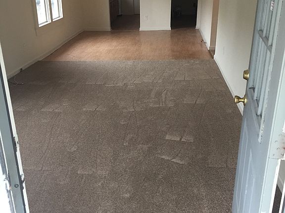 Looking from front door through living room and dining area