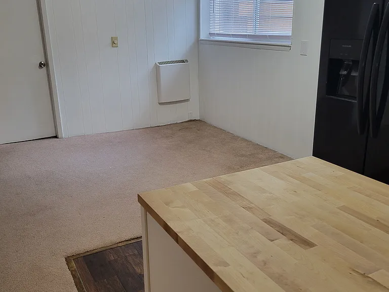 Downstairs dining area with room for six-person table. Brand new, high efficiency, cool touch heating units installed in dining area, living area, and all 3 bedrooms. New carpet coming soon!