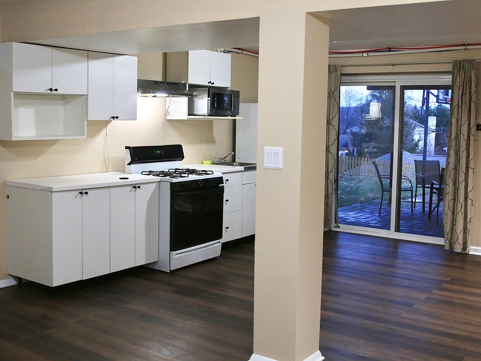 View of kitchen/ dining area from living room, entrance w/ patio in the distance