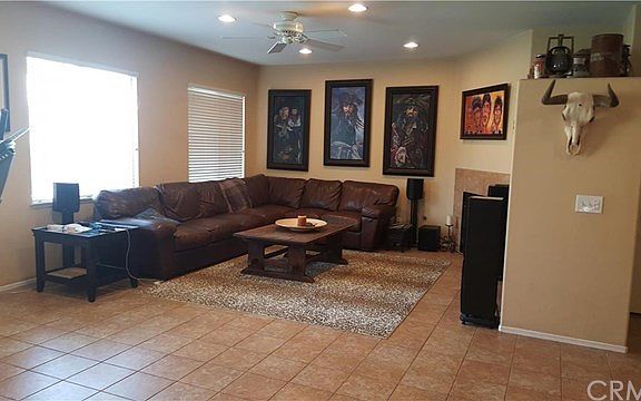 Warm family room with fireplace, ceioling fans and area for HUGE entertainment system.