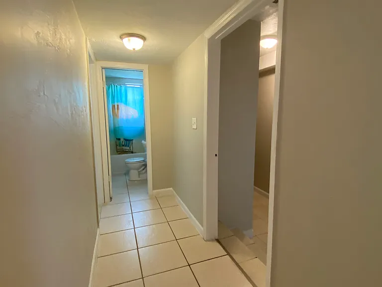 Hallway at back and step down to Master bedroom