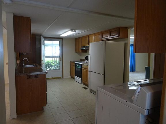 New kitchen cabinets and tile floors with washer, dryer, dis