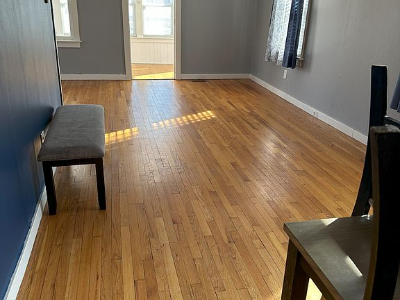 hardwood floors this is dining area off kitchen , further down is living room area and entrance to heated/cooled porch area