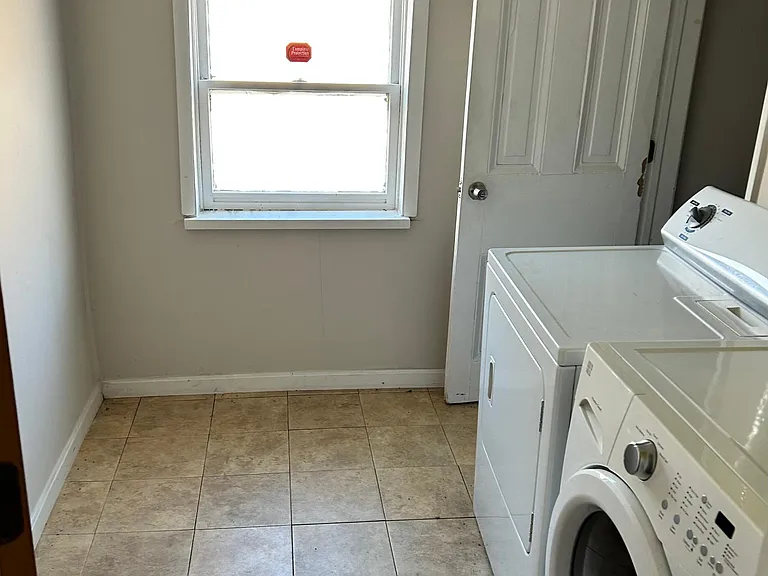 Laundry room is in the back behind the kitchen, and leads to the bathroom.