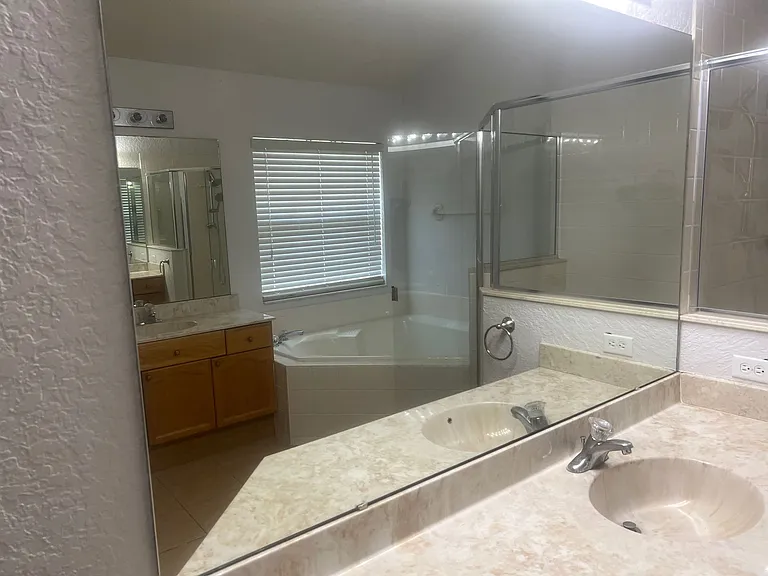 61 - Spacious master bathroom with double sink and large mirror.