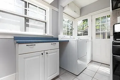 Main level Washer & Dryer with ironing area. Back door to fenced yard.
Refrigerator is across from the Washer.