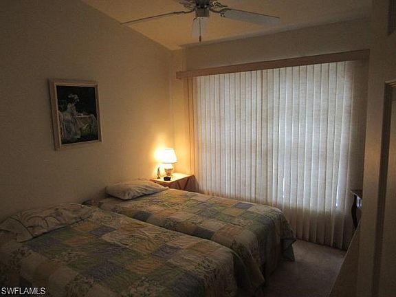 Bedroom 2 with windows opening to the private courtyard.