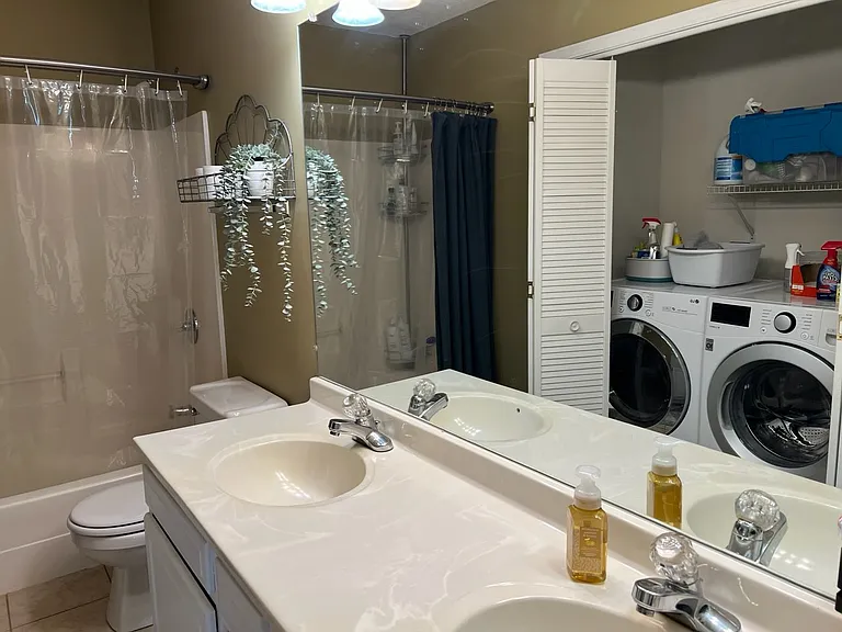 Upstairs bathroom. Room has washer and dryer