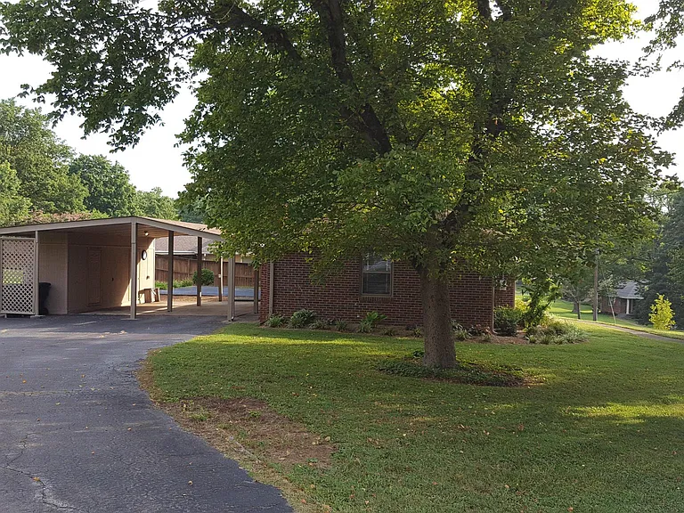 Driveway straight into a double carport with work shed attached. High ceilings to handle trucks.