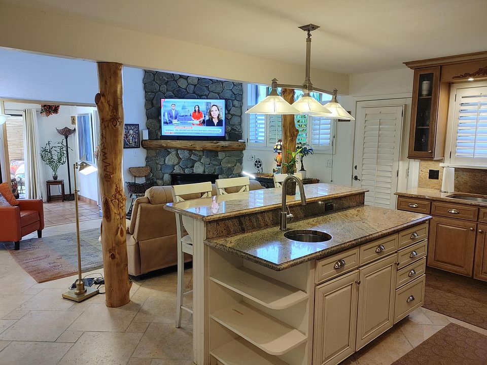 Kitchen and living area, open and light with 2 story ceiling in living.