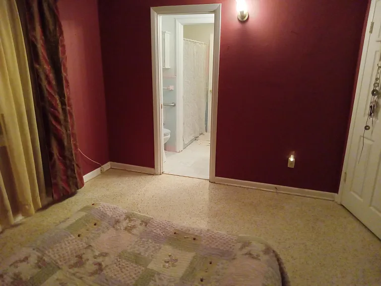 From the master bedroom, just steps to the bathroom. This is looking from the bed to the bathroom. It's a California style bathroom. It's a toilet, then a shower, then another toilet, (in an L-shape) with separating doors/rooms for each room, for privacy