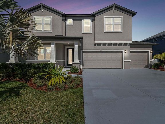 Juniper new construction quick move-in craftsman elevation at dusk at Tea Olive Terrace Palmetto, FL