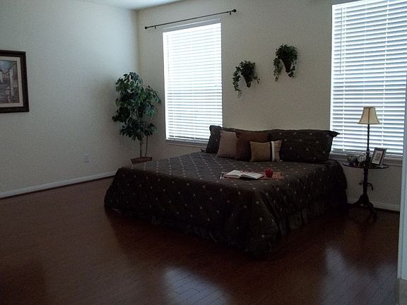 Master bedroom is large with beautiful wood floors.
