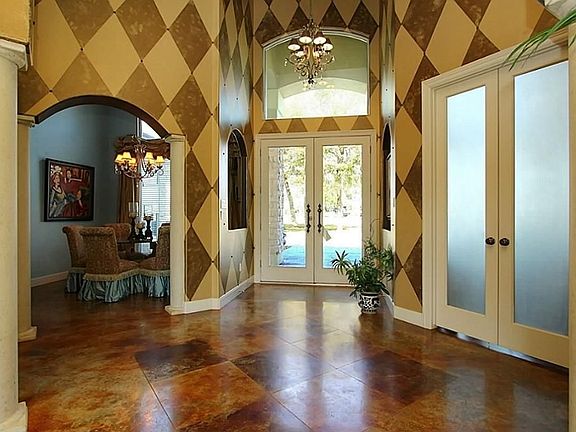 Grand entry. This entire home features custom faux painting, stamped concrete flooring , plus all windows & doors have insulated glass